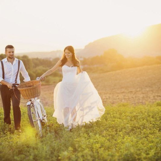 Bride and groom with a white wedding bike
