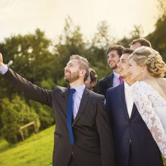 Bride with groom and his friends taking selfie