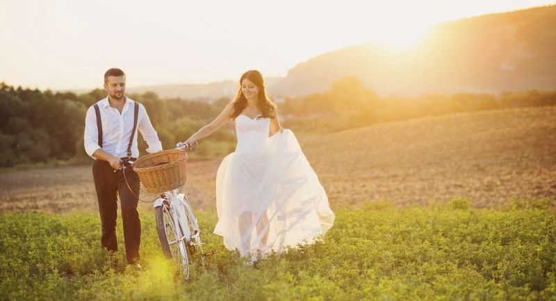 Bride and groom with a white wedding bike