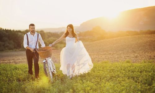 Bride and groom with a white wedding bike